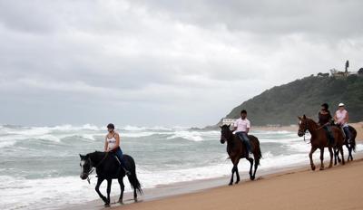 Riding horses on the beach. How romantic!